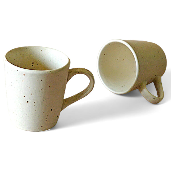 Display image of Speckled cream ceramic mug with a rustic matte finish and simple handle.