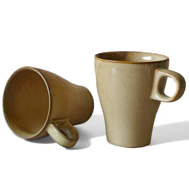 Display image of light brown ceramic coffee mug with a glossy finish and ergonomic handle.