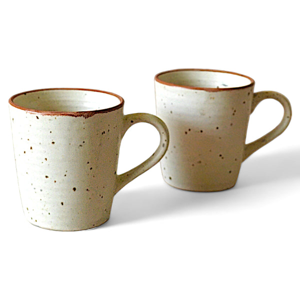 Display image of handcrafted speckled ceramic mug with rustic finish and earthy tones.