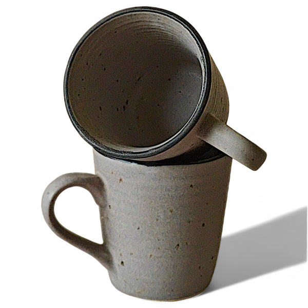 Display image of grey speckled ceramic mugs in a minimalist earthy design with a matte finish.