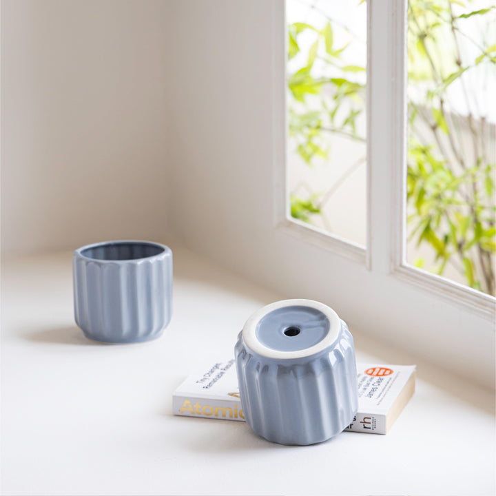 Display image of blue grey ceramic planter with a ribbed texture and glossy finish.