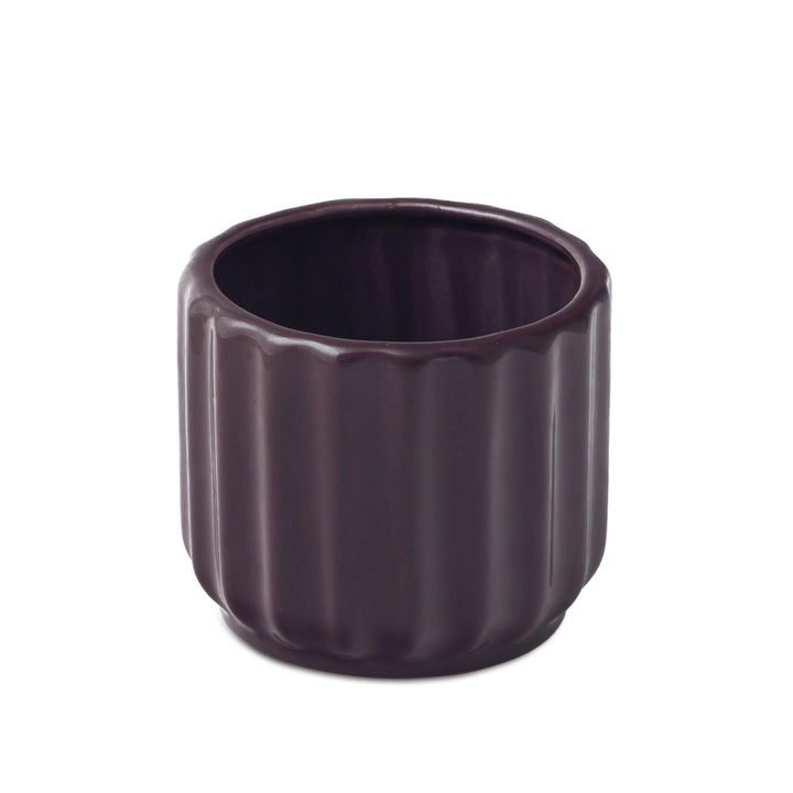 Display image of plum ceramic planter with a ribbed texture and glossy finish.