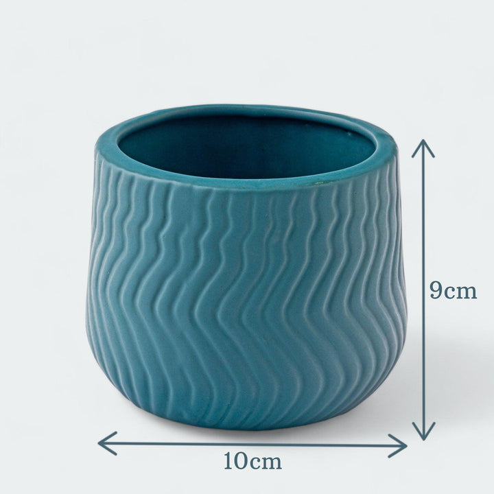 Display image of deep sea green  ceramic planter with a wavy textured pattern and matte finish.