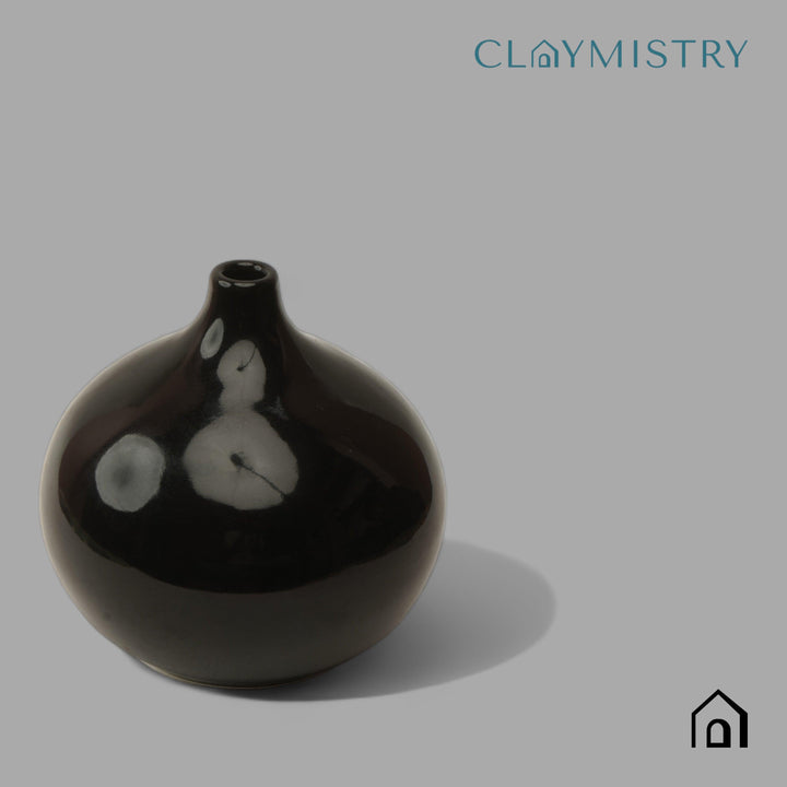 Display image of black ceramic vase with a round bulbous shape and narrow neck.