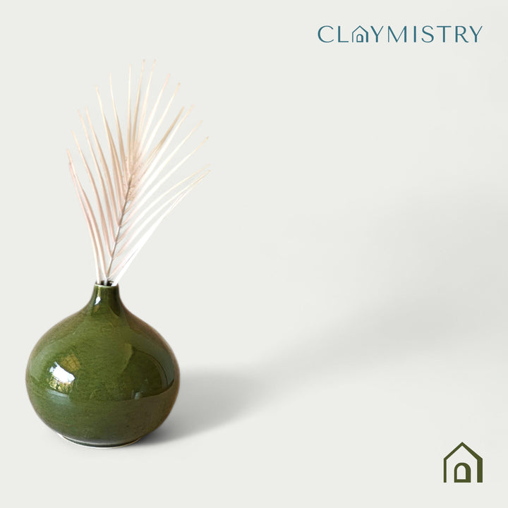 Display image of olive green ceramic vase with a round bulbous shape and narrow neck.