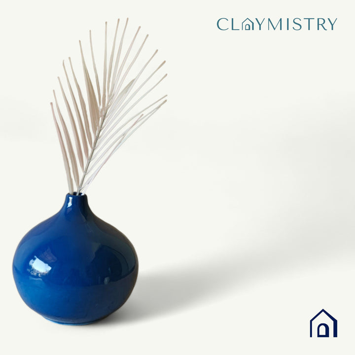 Display image of Glossy blue ceramic vase with a round bulbous shape and narrow neck.