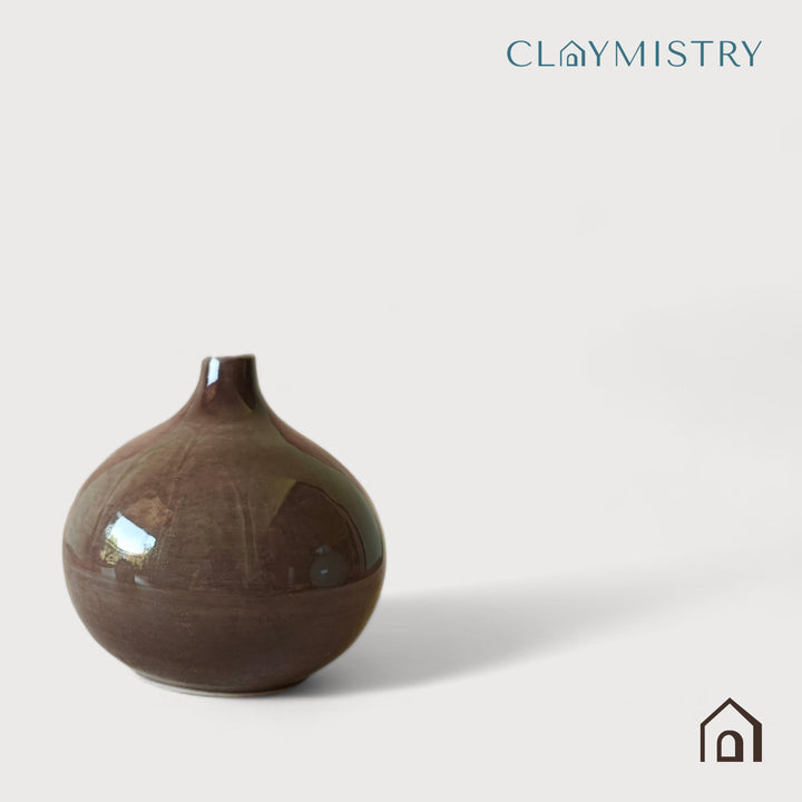 Display image of brown ceramic vase with a round bulbous shape and narrow neck.