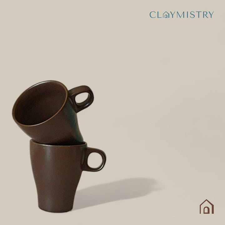 Display image of brown ceramic coffee mug with a glossy finish and ergonomic handle.