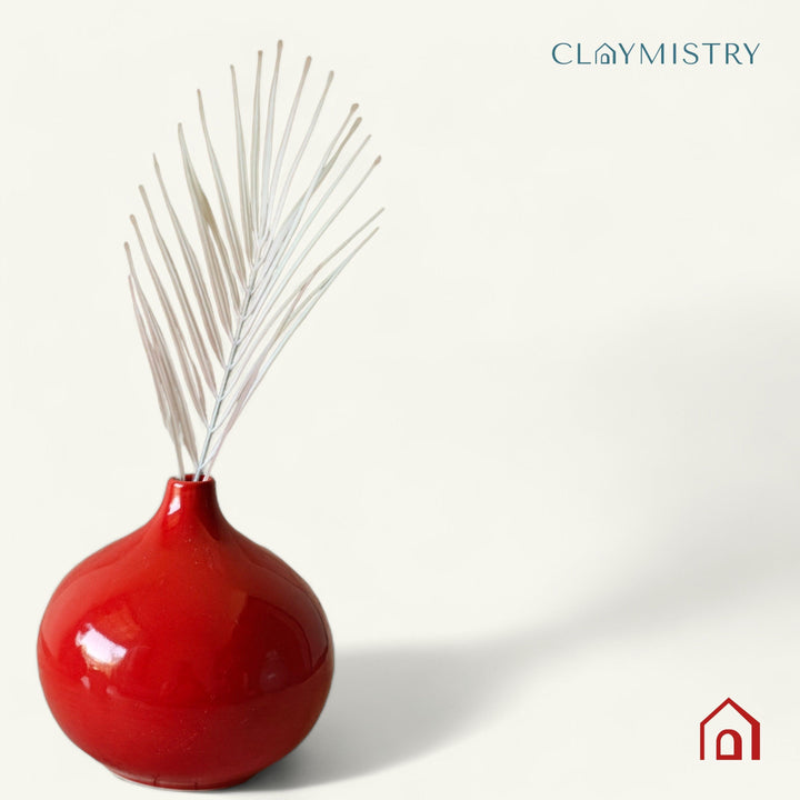 Display image of red ceramic vase with a round bulbous shape and narrow neck.