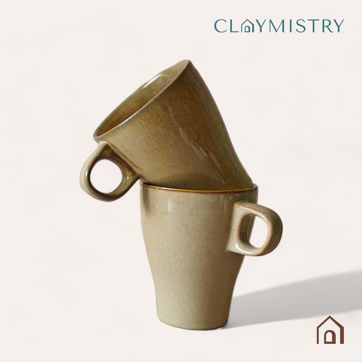 Display image of light brown ceramic coffee mug with a glossy finish and ergonomic handle.