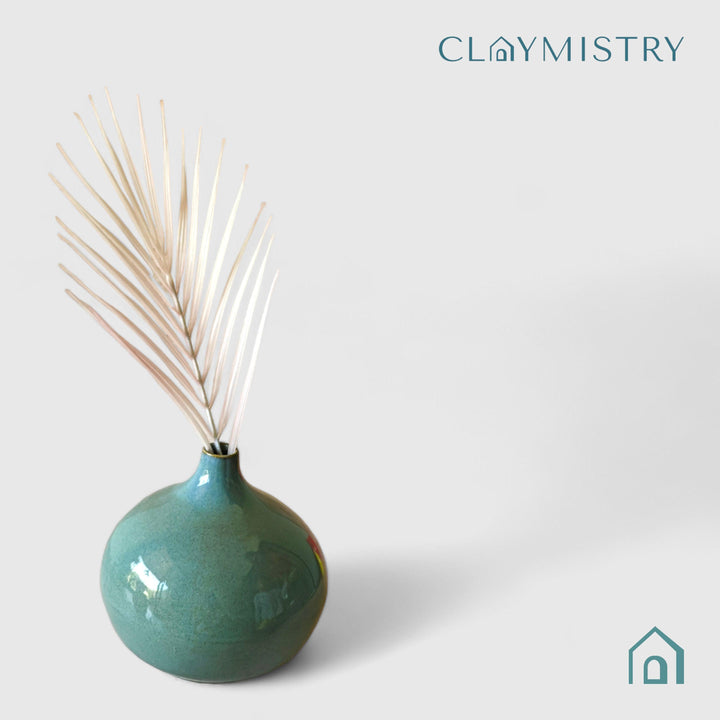 Display image of sea green ceramic vase with a round bulbous shape and narrow neck.