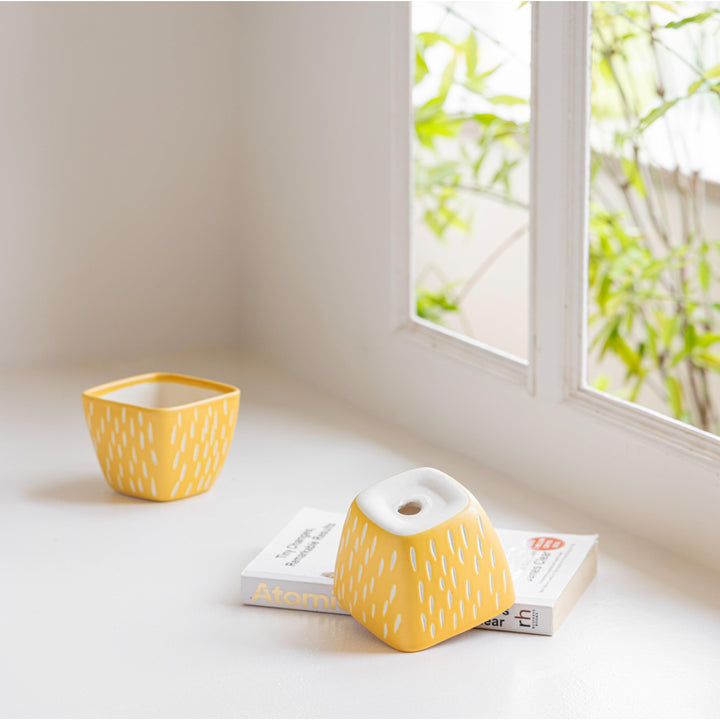 Display image of Splash of Style: The Raindrop Planter - Handmade yellow ceramic raindrop planter featuring a playful design, high-quality durable construction, and non-slip base, perfect for showcasing a variety of plants while adding a vibrant touch of color and whimsy to your home décor.