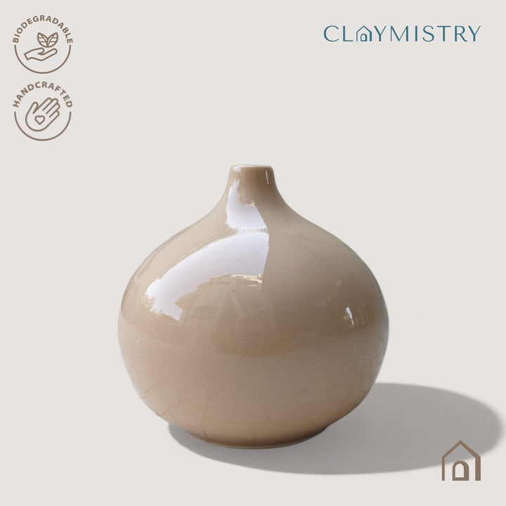 Display image of coffe color ceramic vase with a round bulbous shape and narrow neck.