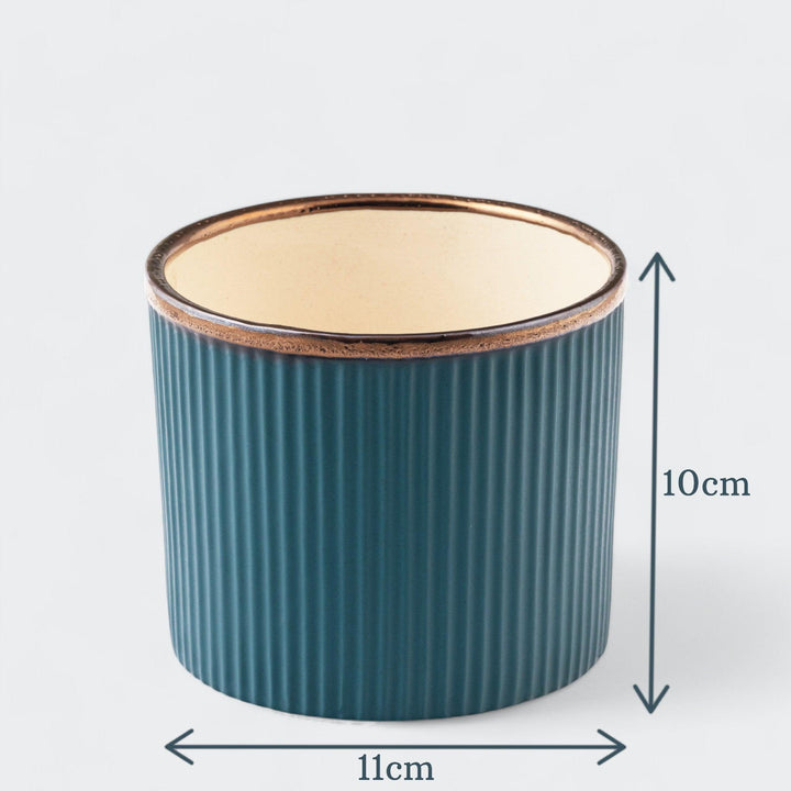 Display image of deep sea green  ceramic planter with a ribbed texture and brown rim, featuring a matte finish.