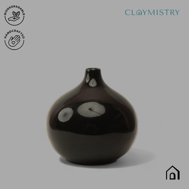 Display image of black ceramic vase with a round bulbous shape and narrow neck.