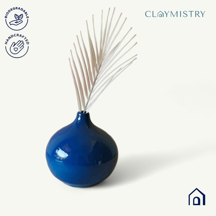 Display image of Glossy blue ceramic vase with a round bulbous shape and narrow neck.