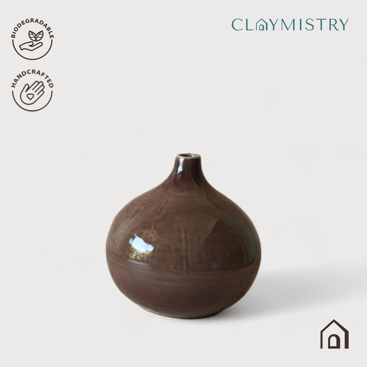 Display image of brown ceramic vase with a round bulbous shape and narrow neck.