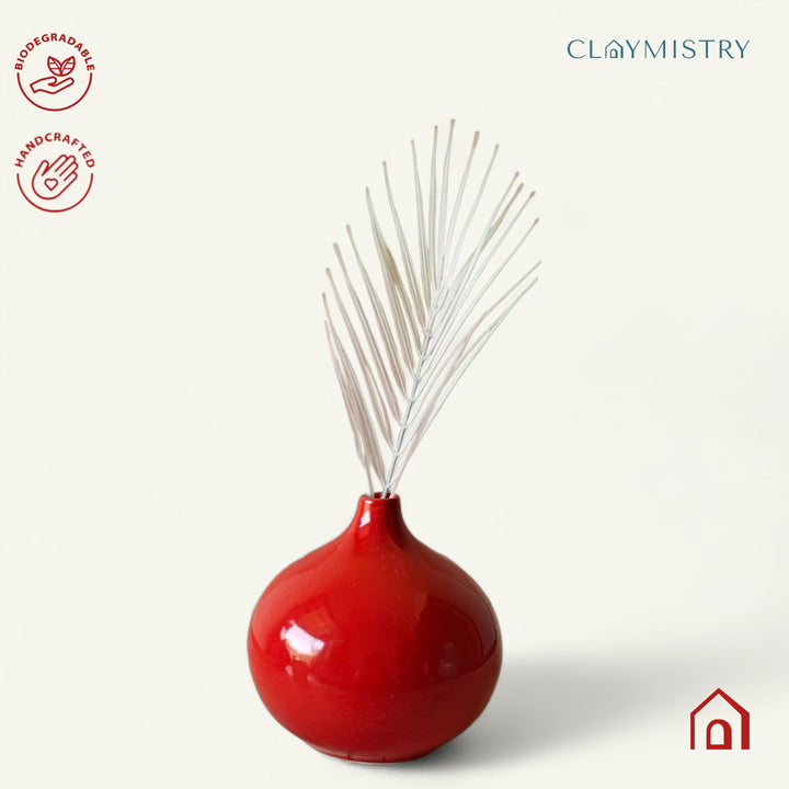 Display image of red ceramic vase with a round bulbous shape and narrow neck.