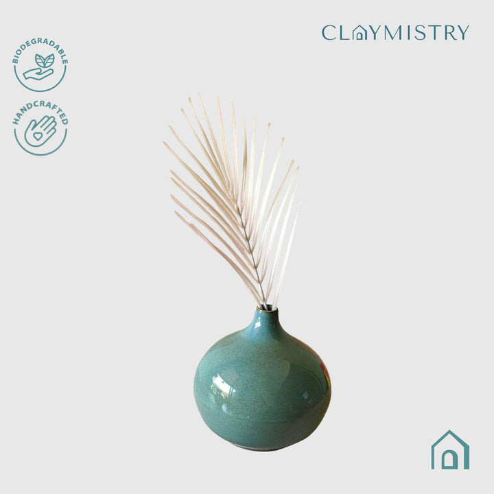 Display image of sea green ceramic vase with a round bulbous shape and narrow neck.