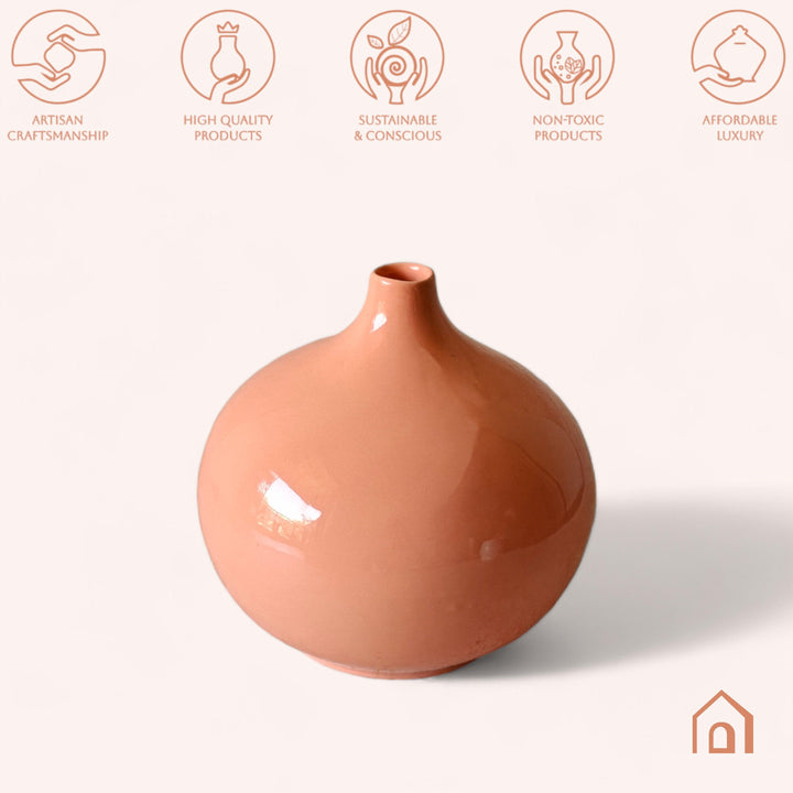 Display image of Glossy peach ceramic vase with a round bulbous shape and narrow neck.