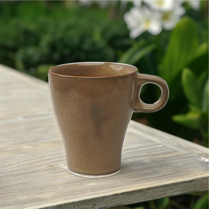 Display image of light brown ceramic coffee mug with a glossy finish and ergonomic handle.