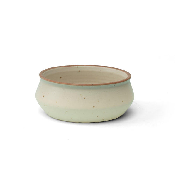 Display image of Handcrafted ceramic bowl with a soft cream matte finish and a brown rim.