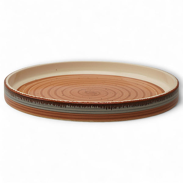 Display image of Sunset Swirl Tray: Warmth & Wonder – Handcrafted ceramic serving tray with warm sunset hues and swirl design, versatile for serving snacks or displaying décor, non-slip base, microwave and dishwasher safe, made from lead-free, cadmium-free, and arsenic-free materials for safe and stylish home use.