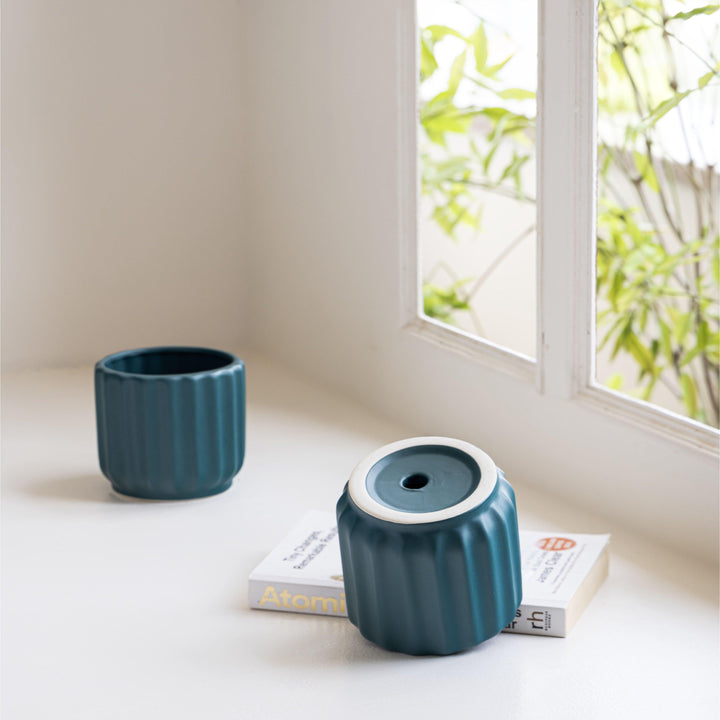 Display image of deep sea green ceramic planter with a ribbed texture and glossy finish.